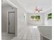View of living room featuring ample light, ceiling fan, and tile flooring at 8075 48Th N Ave, St Petersburg, FL 33709