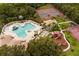 Aerial view of community pool and playground, with nearby tennis and basketball courts at 826 Honeyflower Loop, Bradenton, FL 34212