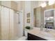 Bathroom featuring a shower and vanity with a granite countertop at 826 Honeyflower Loop, Bradenton, FL 34212