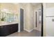 Beautiful bathroom with dark wood cabinets, marble countertops, and neutral patterned wallpaper at 826 Honeyflower Loop, Bradenton, FL 34212