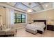 Beautiful bedroom featuring a decorative ceiling, hardwood floors, and a backyard view at 826 Honeyflower Loop, Bradenton, FL 34212