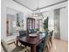 Elegant dining room featuring a dark wood table, green leather chairs, and a decorative mirrored cabinet at 826 Honeyflower Loop, Bradenton, FL 34212