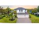 Beautiful two-story home with a manicured lawn, a brick driveway, and a three-car garage at 826 Honeyflower Loop, Bradenton, FL 34212