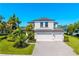 Beautiful two-story home with a three car garage, tropical landscaping, and a brick paver driveway at 826 Honeyflower Loop, Bradenton, FL 34212