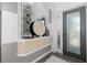 An inviting foyer with modern decor, featuring a decorative mirror wall and elegant accents at 826 Honeyflower Loop, Bradenton, FL 34212