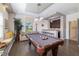 Spacious game room with a pool table, seating, and a wet bar with hardwood floors and recessed lighting at 826 Honeyflower Loop, Bradenton, FL 34212