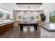 Spacious game room featuring a pool table, media display, hardwood floors, and large window seating at 826 Honeyflower Loop, Bradenton, FL 34212
