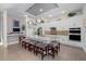 Bright kitchen features a large island with seating, pendant lights, and white cabinetry at 826 Honeyflower Loop, Bradenton, FL 34212