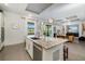 Open floor plan kitchen featuring granite island with pendant lighting and stainless steel appliances at 826 Honeyflower Loop, Bradenton, FL 34212