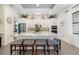 Modern kitchen showcasing a granite island, stainless steel appliances, and white cabinetry at 826 Honeyflower Loop, Bradenton, FL 34212