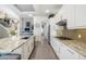 Spacious kitchen with granite countertops, stainless steel appliances, and bright white cabinets at 826 Honeyflower Loop, Bradenton, FL 34212