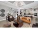 Spacious living room with sleek decor, statement chandelier, and open flow to the kitchen at 826 Honeyflower Loop, Bradenton, FL 34212