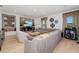 Spacious living room with media center, large sectional couch, and views of the outdoor landscape at 826 Honeyflower Loop, Bradenton, FL 34212