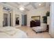 Spacious bedroom with a decorative ceiling, hardwood floors, and a backyard view at 826 Honeyflower Loop, Bradenton, FL 34212