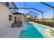 The large, inviting pool has an attached jacuzzi spa and overlooks a scenic lake in a screened-in enclosure at 826 Honeyflower Loop, Bradenton, FL 34212
