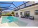 The pool and patio include an outdoor dining table and chairs, plus a full set of living room furniture at 826 Honeyflower Loop, Bradenton, FL 34212