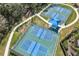 Aerial view of well-maintained tennis and pickleball courts, perfect for sports enthusiasts at 826 Honeyflower Loop, Bradenton, FL 34212