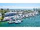 Aerial shot of a marina with docked boats, a parking lot, and a beautiful waterfront view of beachside condos at 830 Trento Dr, Venice, FL 34285
