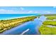 Aerial view of the waterway, coastline, and boat with a wake at 830 Trento Dr, Venice, FL 34285