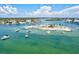 Stunning aerial view of a picturesque island with boats anchored in the clear turquoise water at 830 Trento Dr, Venice, FL 34285