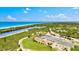 Scenic aerial view highlighting community amenities: tennis courts, basketball court, and waterway access for residents at 830 Trento Dr, Venice, FL 34285