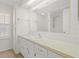 All-white bathroom with vanity, storage, and large mirror at 830 Trento Dr, Venice, FL 34285