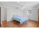 Bright bedroom features wood floors, ceiling fan, and closet at 830 Trento Dr, Venice, FL 34285