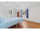 Bright bedroom with a ceiling fan, hardwood floors, and view to exterior window at 830 Trento Dr, Venice, FL 34285