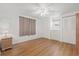 Bright bedroom features wood floors, ceiling fan, and closet at 830 Trento Dr, Venice, FL 34285