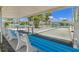 Covered bocce ball court with seating, benches, and palm trees at 830 Trento Dr, Venice, FL 34285