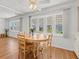 Bright dining area featuring natural light, wood floors and a classic ceiling fan at 830 Trento Dr, Venice, FL 34285