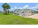 Well-maintained home showing manicured lawn and covered parking at 830 Trento Dr, Venice, FL 34285