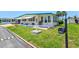 Well maintained house featuring a vibrant green lawn and tastefully decorated landscape at 830 Trento Dr, Venice, FL 34285