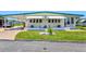 Charming home with awnings, well-kept lawn, carport and front landscaping at 830 Trento Dr, Venice, FL 34285