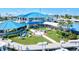 Stunning exterior view of a modern yacht club with manicured lawn, inviting patio, and outdoor seating at 830 Trento Dr, Venice, FL 34285