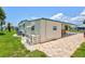 Exterior view of property showcasing covered parking and green space at 830 Trento Dr, Venice, FL 34285