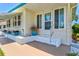 Charming home entrance featuring a vibrant garden bed and a welcoming, covered porch area at 830 Trento Dr, Venice, FL 34285