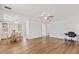 Open-concept living and dining area featuring wood floors, ceiling fans, and bright natural light at 830 Trento Dr, Venice, FL 34285