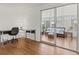 Bright living room featuring a modern desk and sliding glass doors to a cozy sunroom at 830 Trento Dr, Venice, FL 34285