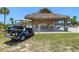 Thatched picnic shelter near a pool, accompanied by a golf cart at 830 Trento Dr, Venice, FL 34285