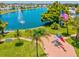 Scenic aerial view of a community pond with a fountain and American flag, symbolizing a peaceful and patriotic setting at 830 Trento Dr, Venice, FL 34285