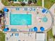 Aerial shot of a community pool with a nearby spa, surrounded by lounge chairs and umbrellas for resident relaxation at 830 Trento Dr, Venice, FL 34285