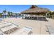 View of the pool area showing lounge chairs and tiki bar structure at 830 Trento Dr, Venice, FL 34285