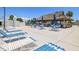 Poolside area featuring picnic tables, lounge chairs, and shade umbrellas at 830 Trento Dr, Venice, FL 34285
