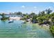 Picturesque waterfront scene featuring a sandy beach, clear water, and lush vegetation for relaxing recreation at 830 Trento Dr, Venice, FL 34285