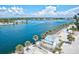 Breathtaking waterfront view featuring clear blue waters, palm trees, sandy beaches, and charming buildings at 830 Trento Dr, Venice, FL 34285