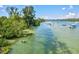 Beautiful waterfront view showcasing a tranquil waterway with boats, lush trees, and clear skies at 830 Trento Dr, Venice, FL 34285