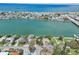 Aerial view of waterfront homes and a canal leading to the ocean at 9300 Gulf Blvd, St Pete Beach, FL 33706