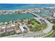 Expansive aerial view showing the bridge, waterfront properties, and a glimpse of the bay at 9300 Gulf Blvd, St Pete Beach, FL 33706