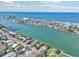 A captivating aerial shot of the coastline, showcasing waterfront homes with easy access to a sandy beach at 9300 Gulf Blvd, St Pete Beach, FL 33706